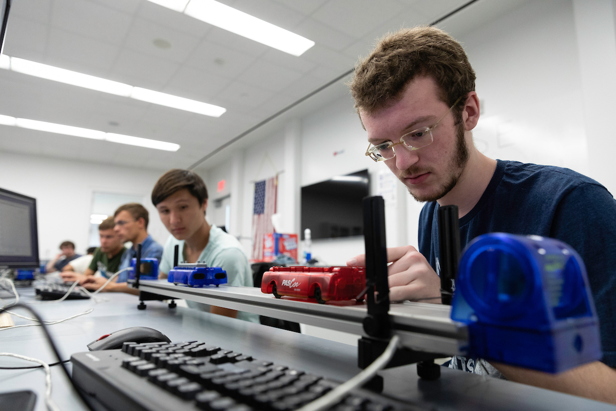 students working in lab on machine